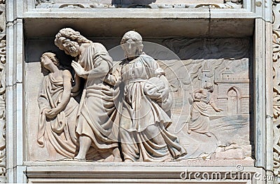 Lot and his daughters flee from Sodom, marble relief on the facade of the Milan Cathedral Stock Photo