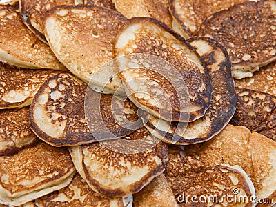 A lot of homemade small thick pancakes close-up. Top view. Traditional russian sweet dessert. Stock Photo