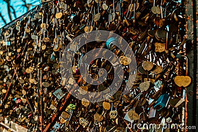 A lot of locks with the names of lovers on the bridge in Paris on montmarte near the Basilica church Stock Photo