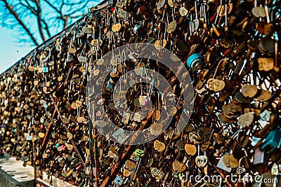 A lot of locks with the names of lovers on the bridge in Paris on montmarte near the Basilica church Stock Photo