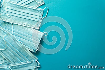 A lot of medical masks on blue background with copyspace. Stock Photo