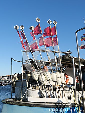 A lot of pole flags on a fisherman's boat Stock Photo