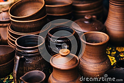 A lot of pottery at the fair. Ceramic national Russian dishes made. Burnt black ceramics. Burnt clay pots and plates, dishesÐ¼. Stock Photo
