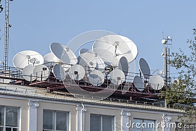 A lot satellite dishes, satellite antennas mounted on the roof. Stock Photo