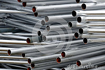 A lot of silver iron pipes piled up. Stock Photo