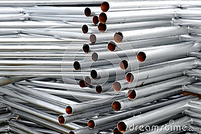 A lot of silver iron pipes piled up. Stock Photo