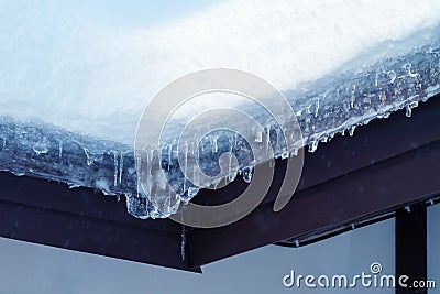 Lot of snow on the roof of a rural cottage Stock Photo
