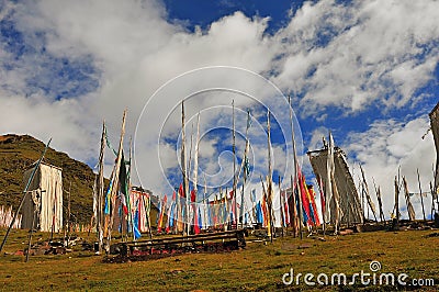 A lot of Tibetan prayer flags flying wiht Mandala on the hillside Editorial Stock Photo