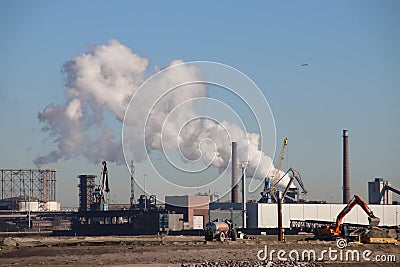 Lot of water vapor coming out of the chimney of ENCI concrete and cement factory in IJmuiden and Velsen. Editorial Stock Photo