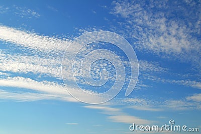 A lot of white clouds of different types: cumulus, cirrus, layered high in blue sky Stock Photo