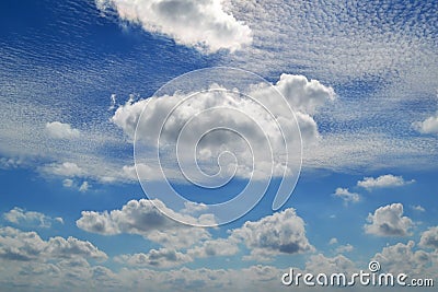 A lot of white clouds of different types: cumulus, cirrus, layered high in blue sky Stock Photo