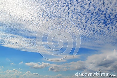 A lot of white clouds of different types: cumulus, cirrus, layered high in blue sky Stock Photo