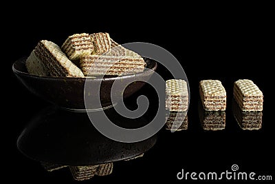 Hazelnut wafer cookie isolated on black glass Stock Photo