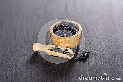 Raw black turtle beans on grey stone Stock Photo