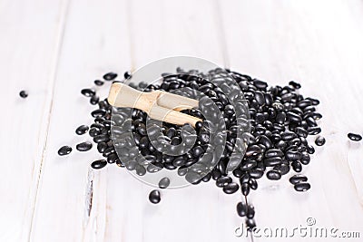 Raw black turtle beans on grey wood Stock Photo