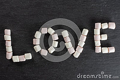 Sweet fluffy marshmallow on grey stone Stock Photo