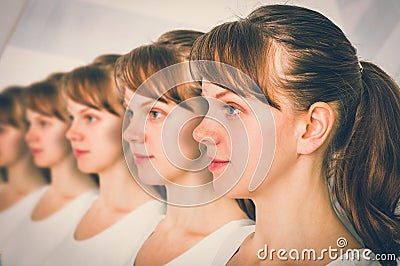 A lot of women in a row - genetic clone concept Stock Photo