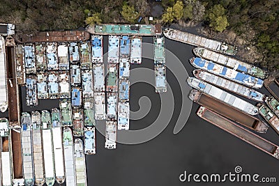 .Lots of abandoned transport barges moored side by side at the wharf. River transport industry Stock Photo