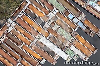 .Lots of abandoned transport barges moored side by side at the wharf. River transport industry Stock Photo