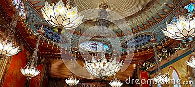 Lots of beautiful painted lamps on the ceiling of the Royal Pavilion. Editorial Stock Photo