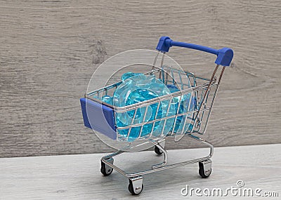 shopping cart filled with blue hearts made of glass Stock Photo