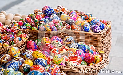 Lots of colorful handmade Easter eggs in multiple baskets, set of many traditional handcrafted Polish pisanki, festival market Editorial Stock Photo