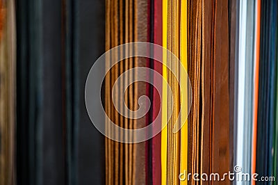 Lots of different coloured leather belts hanging from a rack Stock Photo