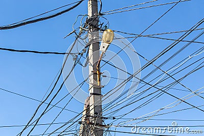 lots of electric wires and a lantern on a pole Stock Photo