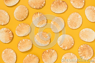 Lots of mini pita bread on yellow background Stock Photo