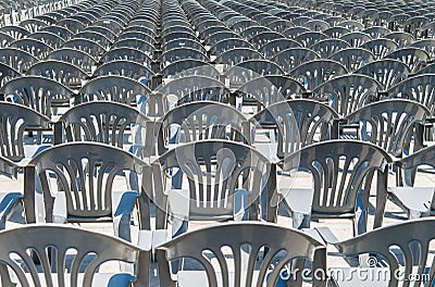 Lots of grey plastic chairs in the row Stock Photo