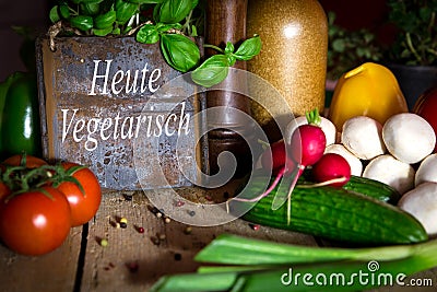 A lots of healthy vegetables on a wooden table, sign with text H Stock Photo