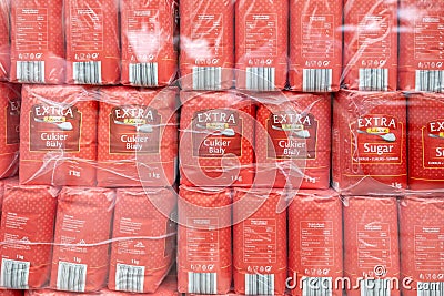 Lots of 1kg packs of Polish brand sugar in storage prepared for sale, sugar production, food necessities many packs of sugar Editorial Stock Photo