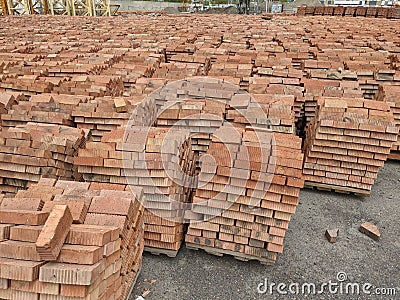 Lots of pallets of bricks. Pallets of new concrete blocks on an outdoor warehouse Stock Photo