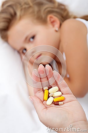 Lots of pills for a sick little girl Stock Photo