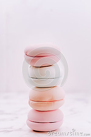 Lots of pink macaroons in a stack on a light background. Macro photography of a group of traditional French round Stock Photo
