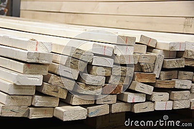 lots sawn boards in the building materials store. building boards Stock Photo