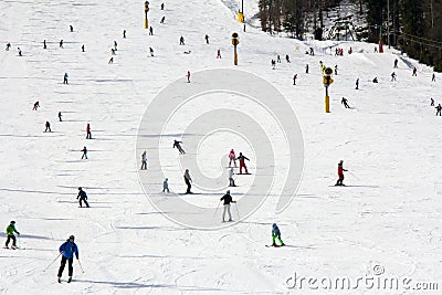 Lots of skiers and snowboarders on the slope Stock Photo