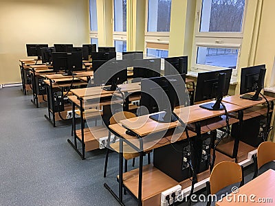 Lots of tables, computers and monitors in the empty classroom Stock Photo