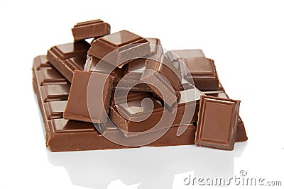 Lots tasty of pieces of broken milk chocolate isolated on white Stock Photo