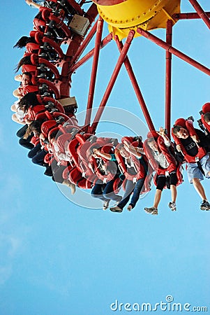 Lots of teenagers young people having fun on wild ride at theme park Editorial Stock Photo