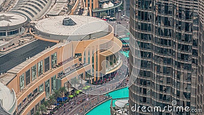 Lots of tourists walking near foutains and shopping mall in Dubai downtown night timelapse Stock Photo
