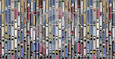 Lots of trucks waiting to be unloaded at the terminal. Top view of hundreds of tractors with trailers Stock Photo