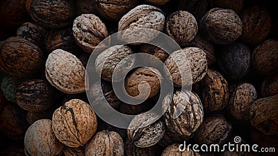 Lots of walnuts close up. Unpeeled walnuts with shells. A bunch of nuts. background. Vegetarian healthy diet Stock Photo