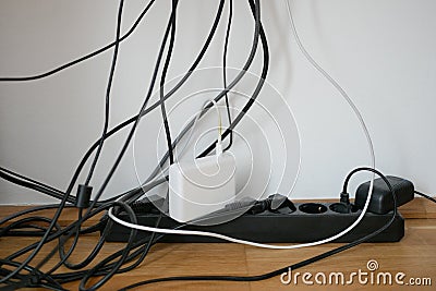 Lots of wires in a socket at work. Cabling chaos. Concept of the problem of saving space and aesthetics Stock Photo