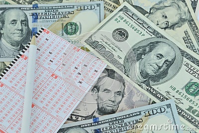 Lottery ticket and pencil on dollar background Stock Photo