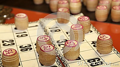 Lotto board game. Wooden lotto barrels and cards. Bingo game. Gambling Stock Photo