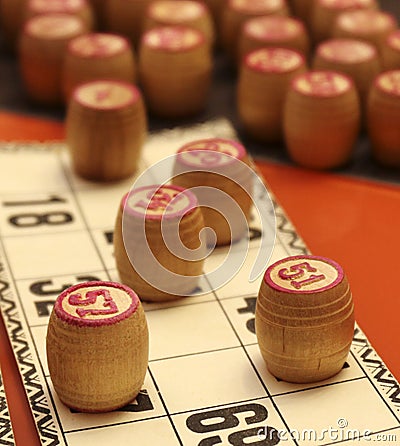 Lotto board game. Wooden lotto barrels and cards. Bingo game. Gambling Stock Photo