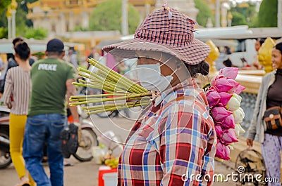 Lotus flowers vendor in a crowded market of Phnom Penh, Cambodia. August 30, 2015 Editorial Stock Photo