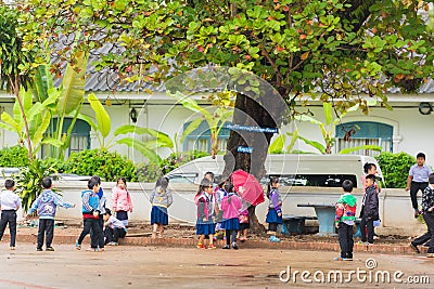 LOUANGPHABANG, LAOS - JANUARY 11, 2017: Children in the school yard. Copy space for text. Editorial Stock Photo