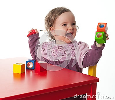 Loughing child with building bricks Stock Photo